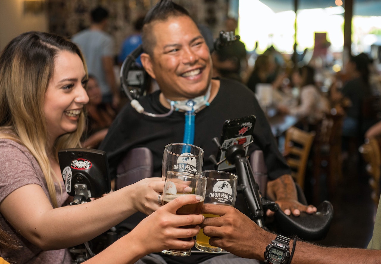 "A group of friends share a toast while at a bar"