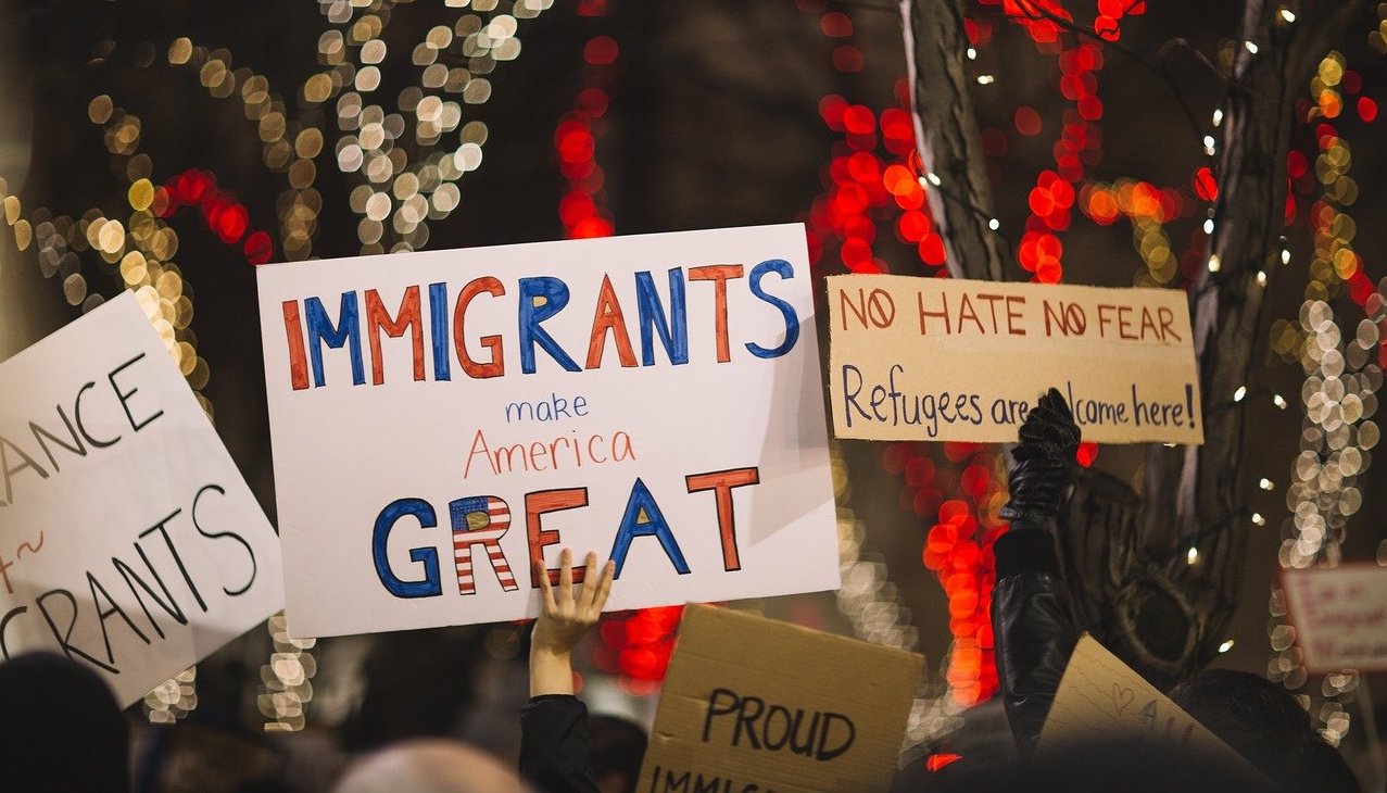 Pro-immigration signs at nighttime vigil
