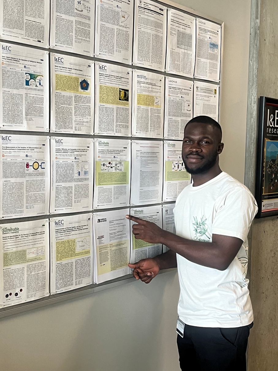 person pinning a printed publication to a bulletin board