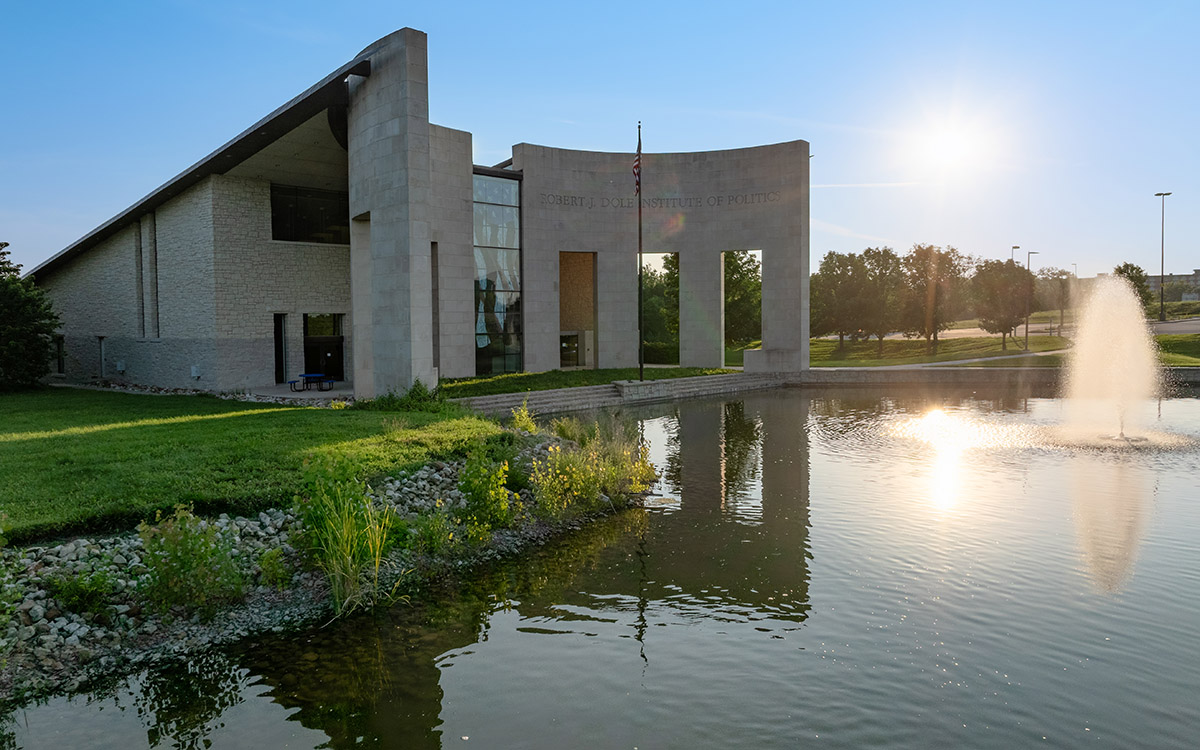 Dole Institute of Politics exterior with reflecting pool on early fall day.