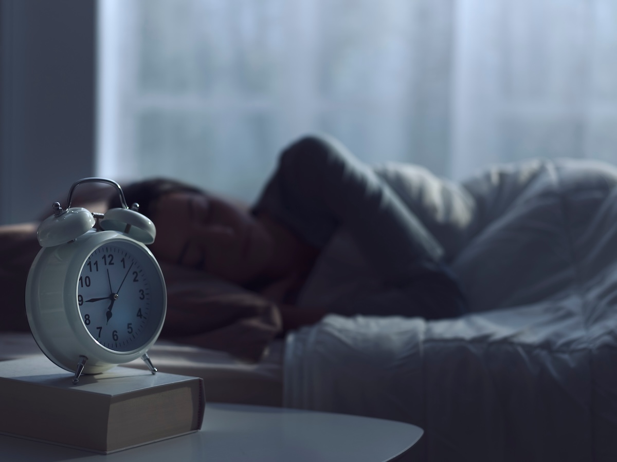 Stock photo of woman sleeping in bed.