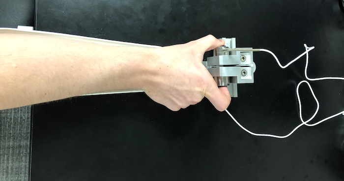The custom-made arm brace and load cells for precision grip testing