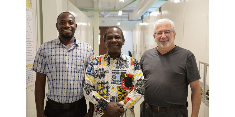 Three men posing for a photo.