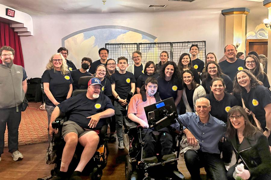 A group of KUCD employees pose for a photo with filmmakers of "The Ride Ahead" during a screening of the show