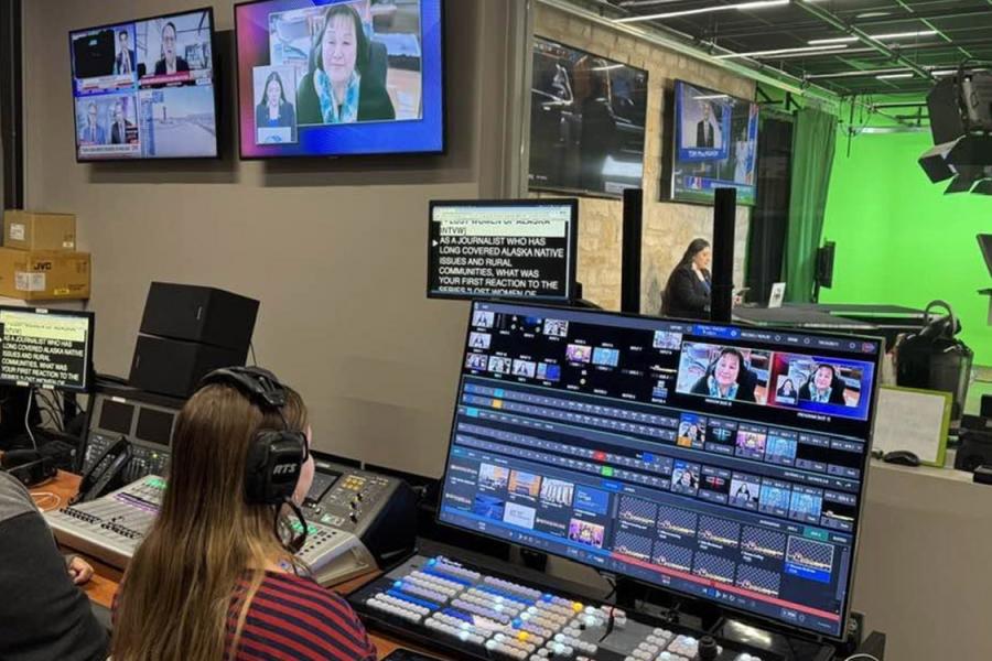 Students working in a studio at a large control board to produce the "Good Morning Indian Country" broadcast.