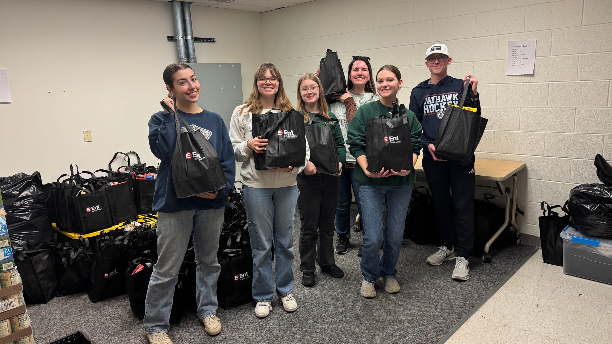 KU students are shown with assembled food bags for families in need in Colorado Springs.