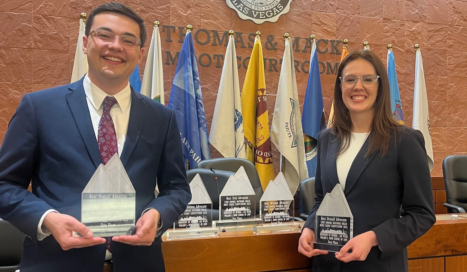 KU Law students Alex Nelson and Ashley MacDonald pose with their awards for winning the 2025 National Native American Law Student Association Moot Court Competition.