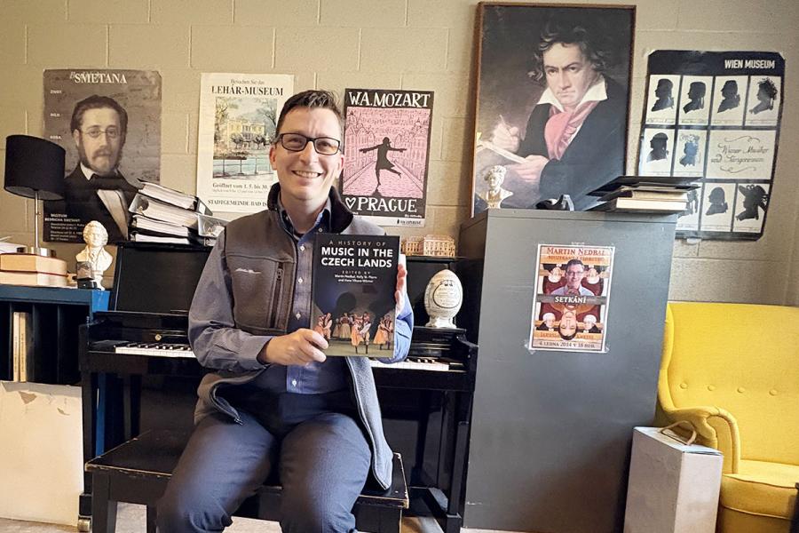 Martin Nedbal holding a copy of his book Music in the Czech Lands