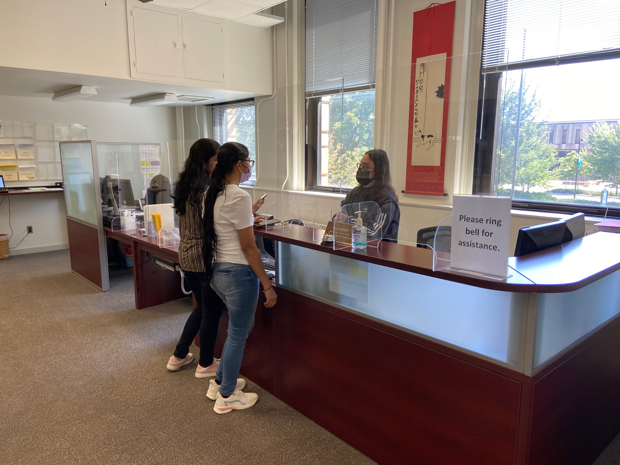 An ISS staff member greets students in the reception area of 126 Strong, a new meeting site for International Support Services.