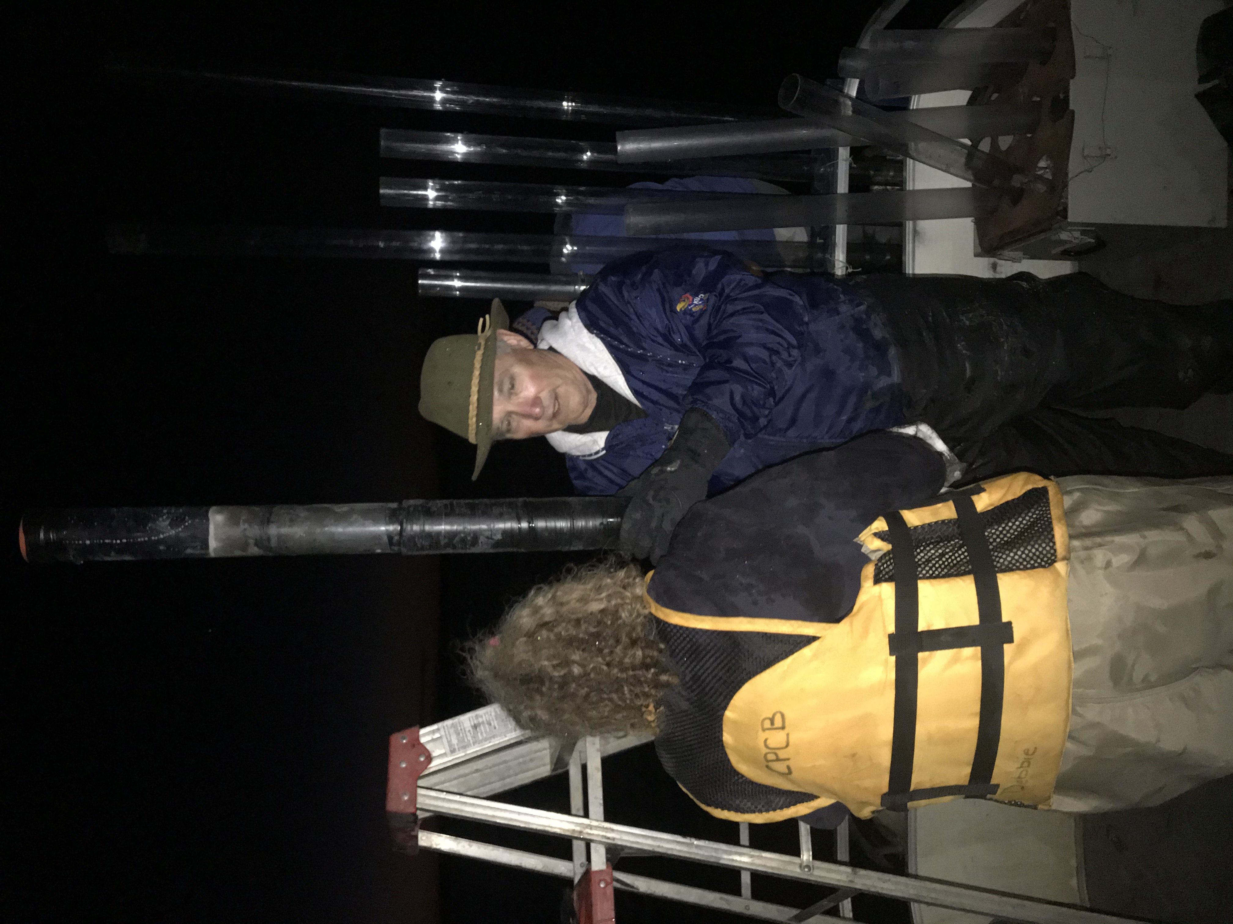 "Jennifer Delisle and Scott Campbell hold a sediment core they collected from Kanopolis lake at night due to high winds during the day."