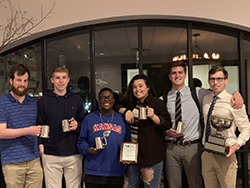 KU Debate team holding awards