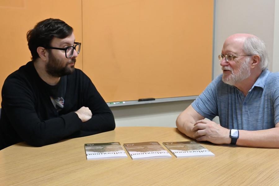 KU Libraries' Eric Bader and Cottonwood's Phil Wedge discuss a recent publication.