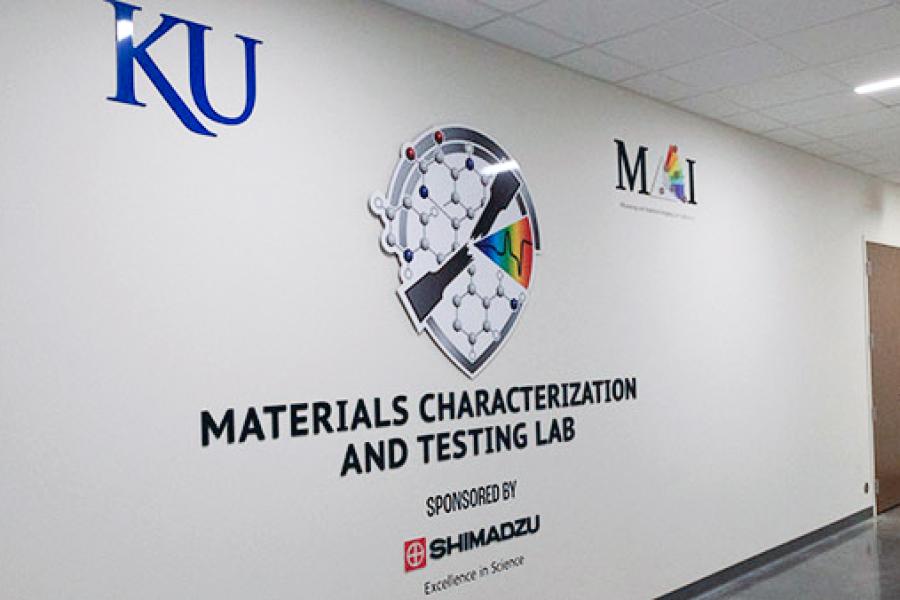 Entrance to the Materials Characterization & Testing Lab that shows logos of the University of Kansas and Shimadzu.