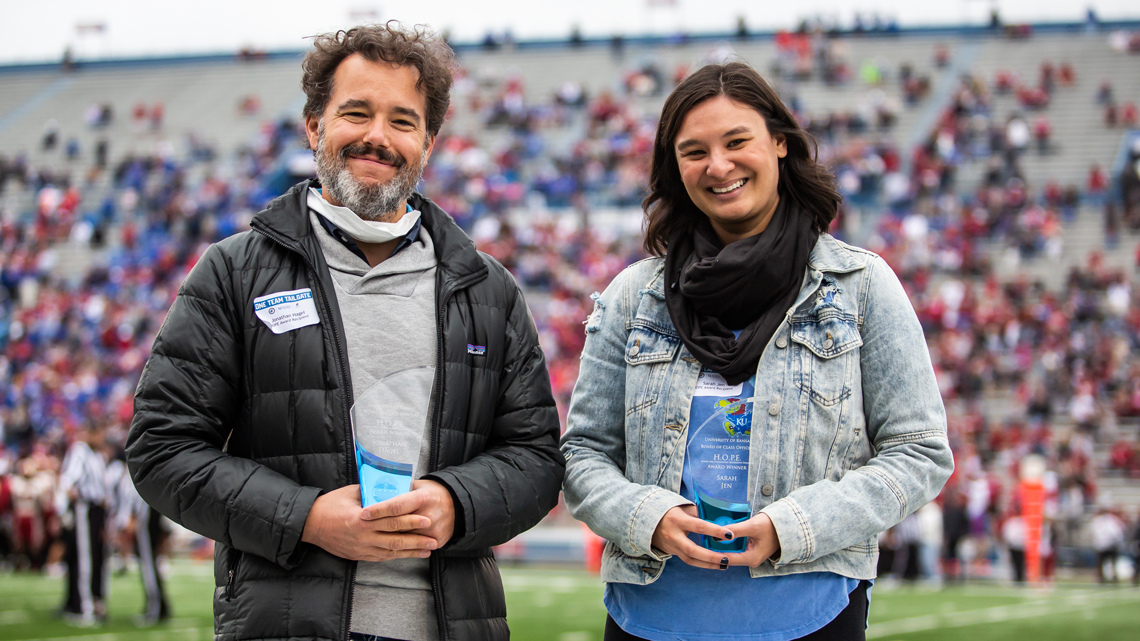 Sarah Jen, assistant professor of social welfare, and Jonathan Hagel, assistant teaching professor of history, receiving 2021 HOPE Awards — to Honor an Outstanding Progressive Educator at the KU Football Game against Oklahoma. 