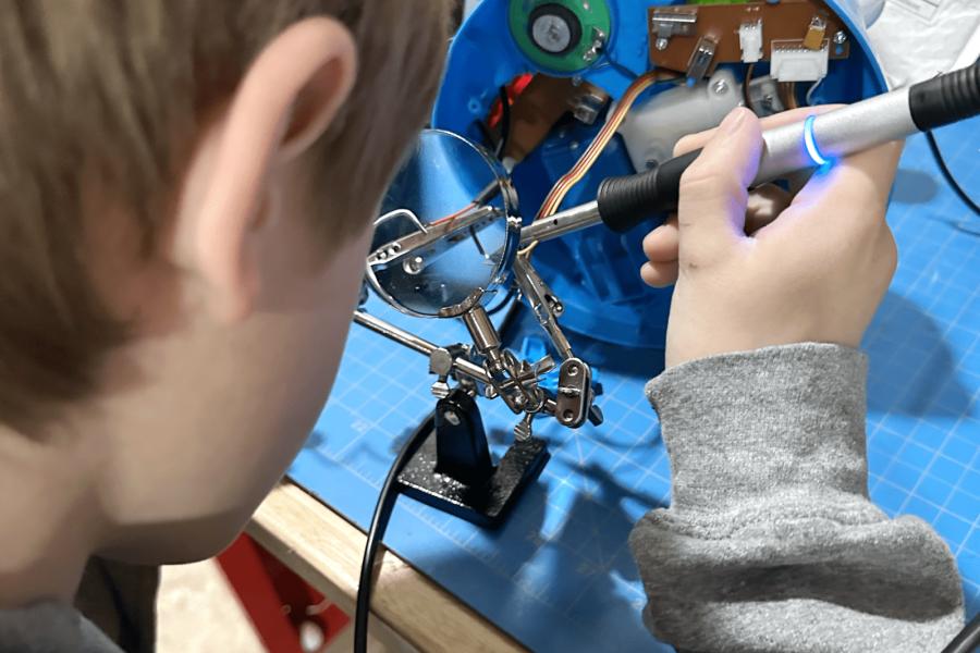 A child works on adapting a child's toy