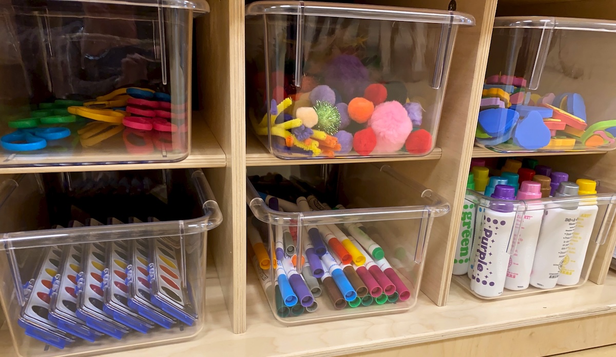 Plastic tubs of early childhood school supplies