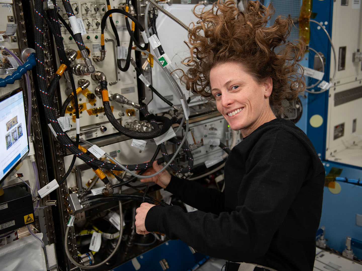 NASA astronaut and Expedition 70 Flight Engineer Loral O'Hara replaces hardware inside the Plant Habitat facility to prep for future experiments investigating genetic responses and immune system function of tomatoes in microgravity. Credit: NASA