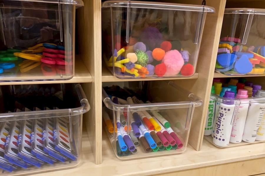 Plastic tubs of early childhood school supplies