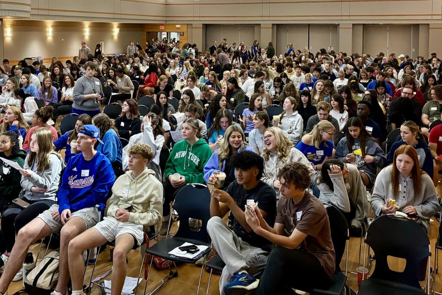 Crowd of students in auditorium.