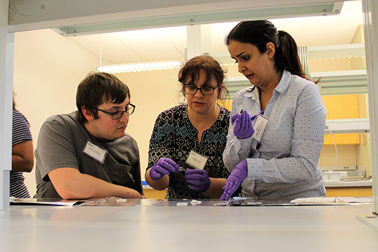 Aaron, left, and Mahsa, right, learn how to place the silver electrodes.