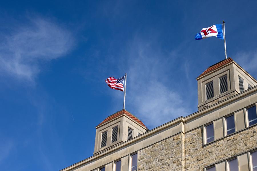 American, KU flags atop Fraser Hall.