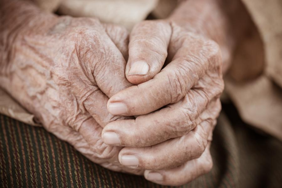 A photo of a pair of elderly wrinkled hands.