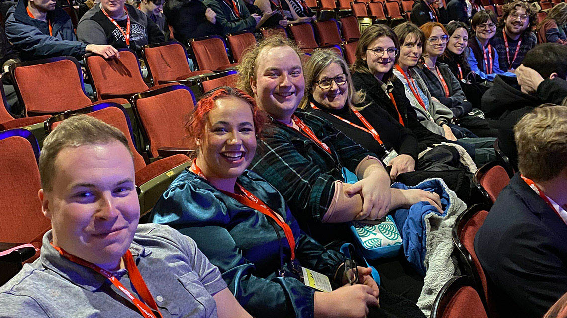 Department of Theatre & Dance contingent representing at KCACTF Region V Festival. Individuals in theatre seats in a large theatre space.