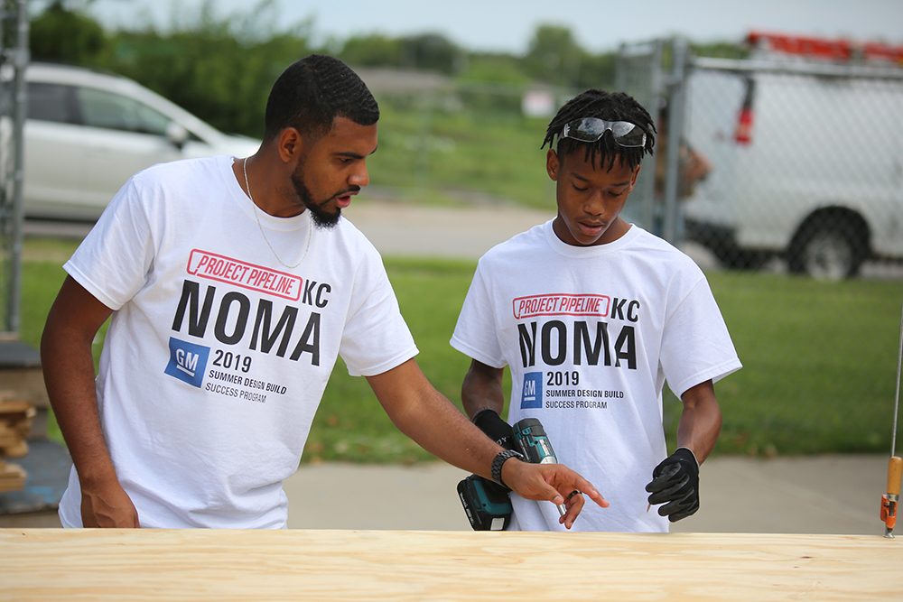 Darius Mathis (left) teaches construction techniques at the 2019 Project Pipeline summer camp in Kansas City, Missouri.