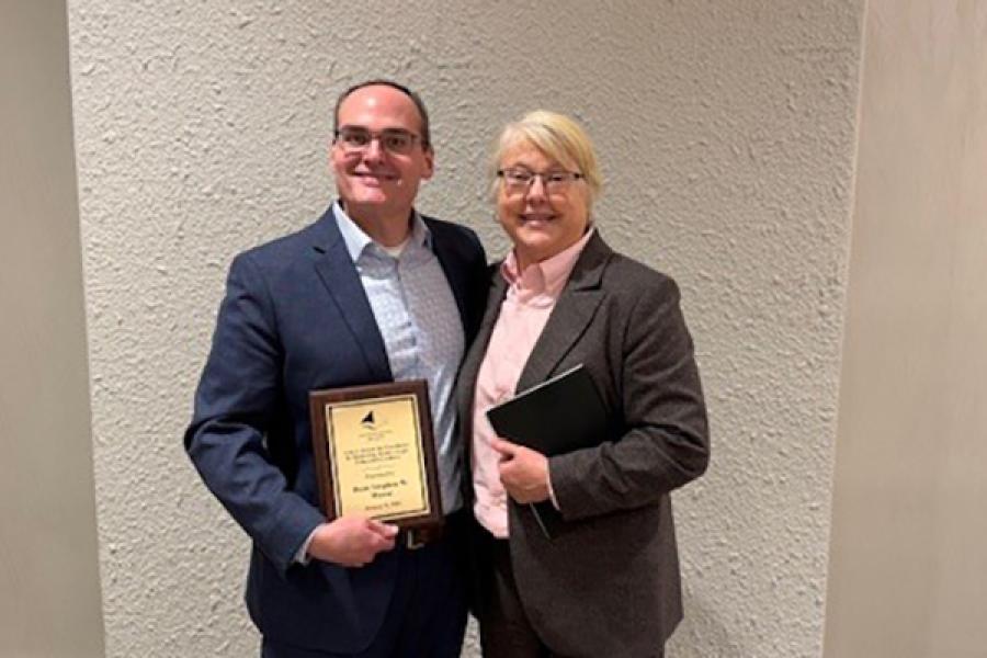 University of Kansas School of Law Dean Stephen Mazza poses with AALS President Kellye Testy while holding a plaque for his Excellence in Mentoring Future Legal Education Leaders Award