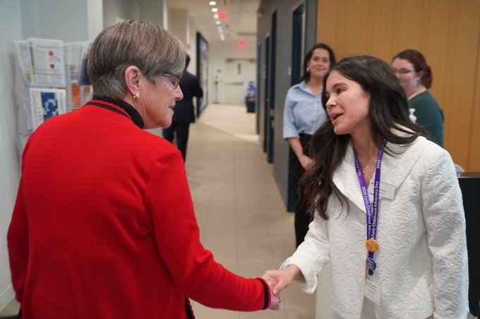 Honors student shakes hand with Kansas governor Laura Kelly