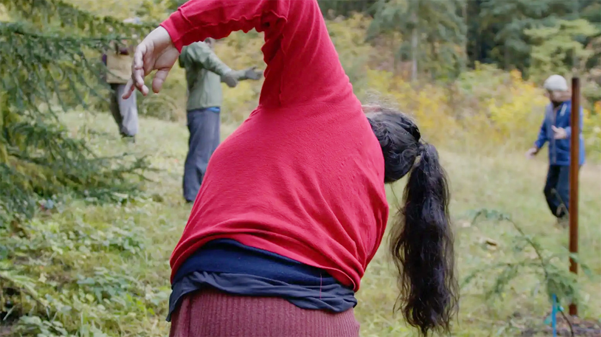 People dancing in the woods