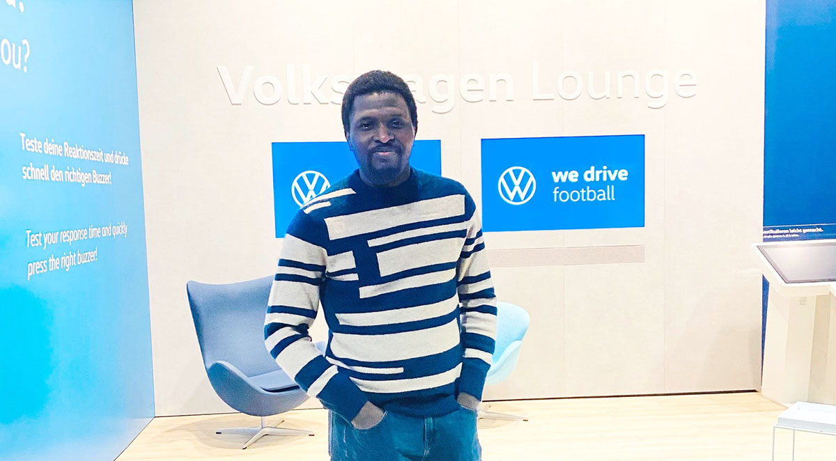 Author James Yékú stands in the Volkswagen Lounge of the German Football Museum in Dortmund.