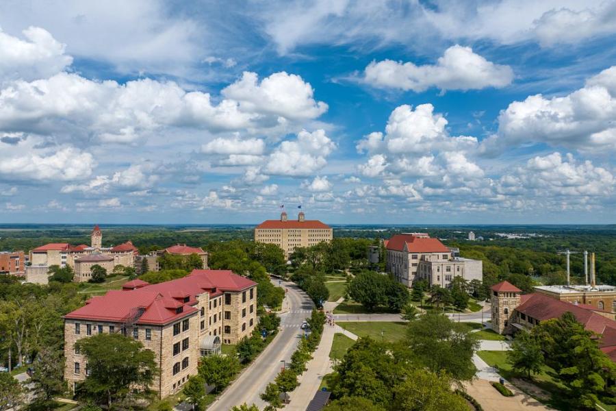 Blue skies and puffy clouds over the hill in Lawrence