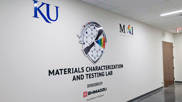 Entrance to the Materials Characterization & Testing Lab that shows logos of the University of Kansas and Shimadzu.