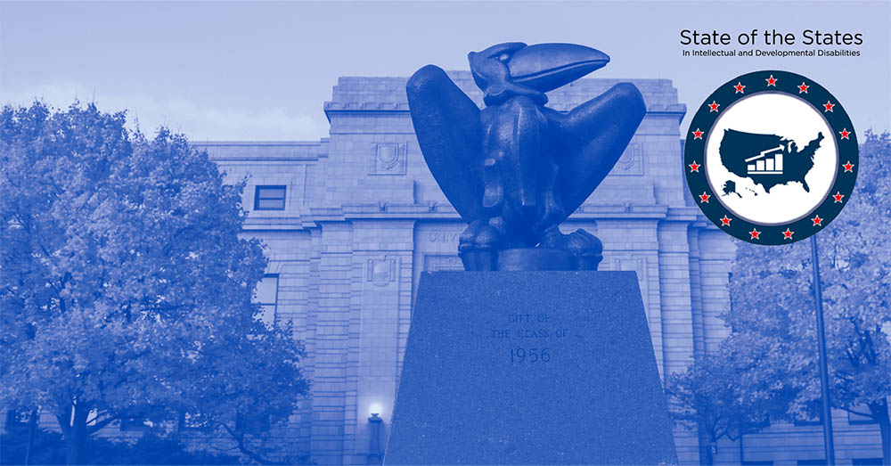 A blue-tinted image of a statue of the Jayhawk is shown on the KU campus with a logo and text for the State of the State in Intellectual Developmental Disabilities.