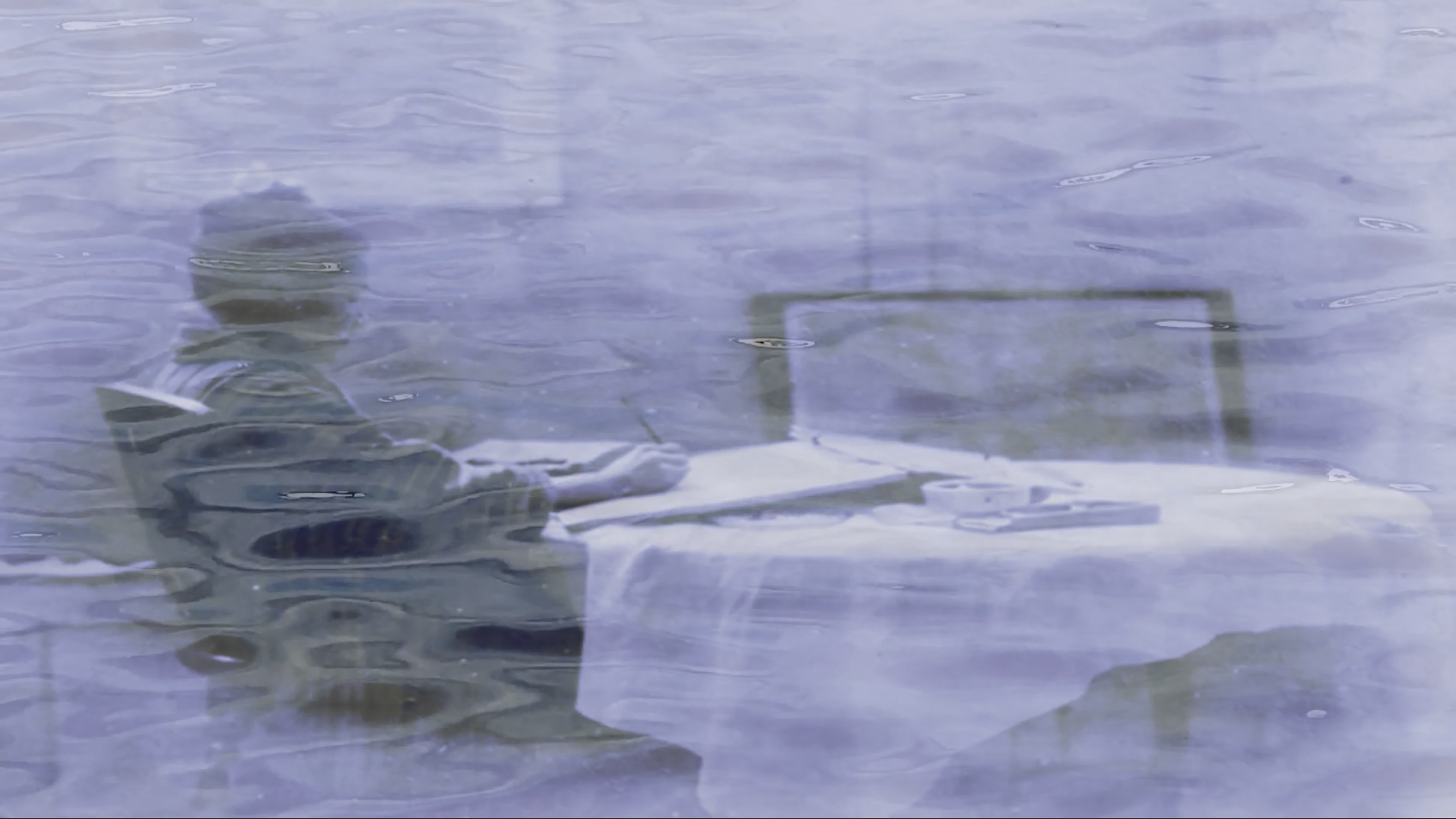 An image of a woman sitting at a table painting overlaid on an image of rippling water