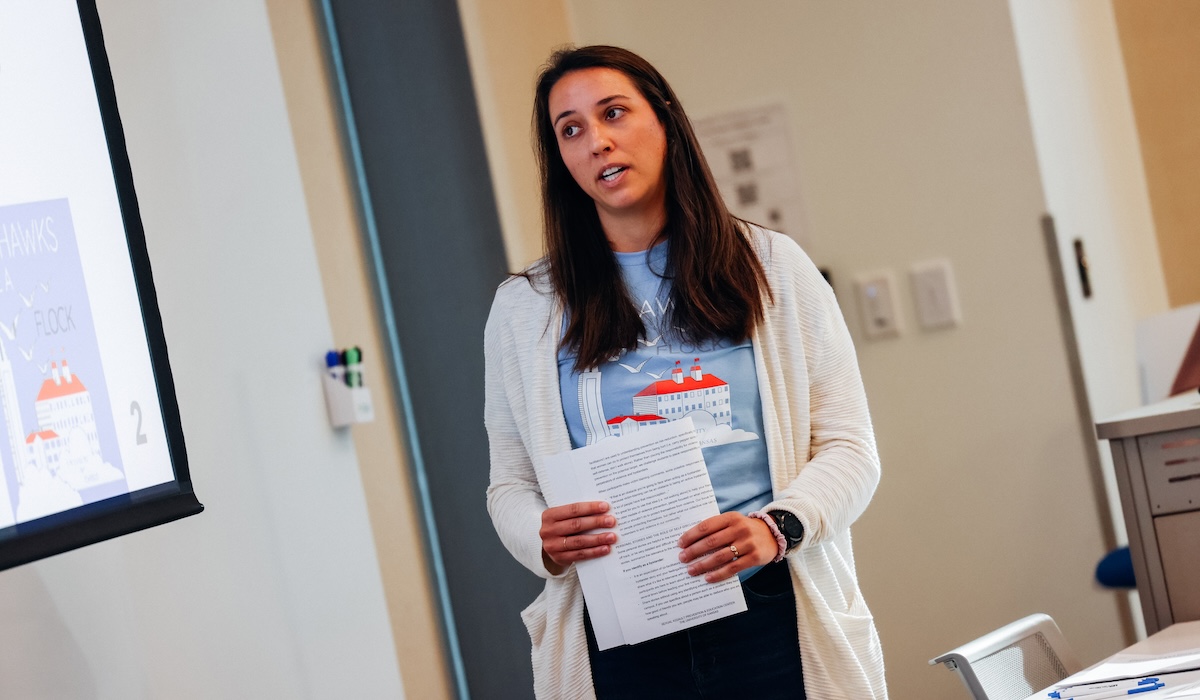 Facilitator speaks to students in classroom
