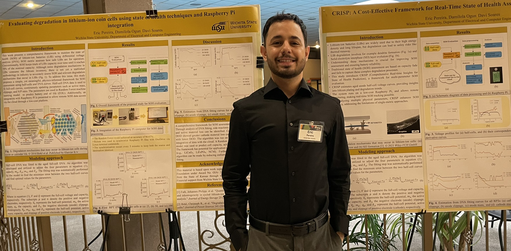 Student stands next to poster