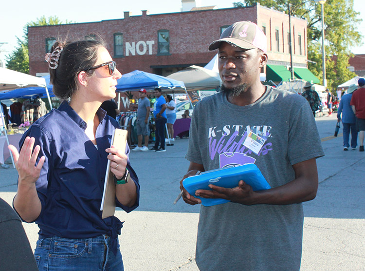 Two researchers survey KC residents at outdoor event