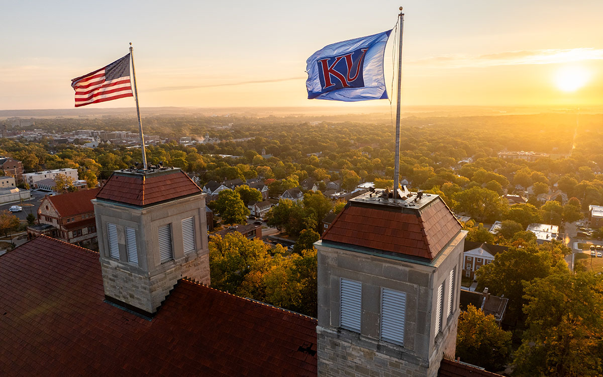 KU, American flags fly atop Fraser Hall.