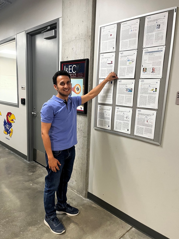 Arishi Abdulrhman pins his research to the publication wall at KU