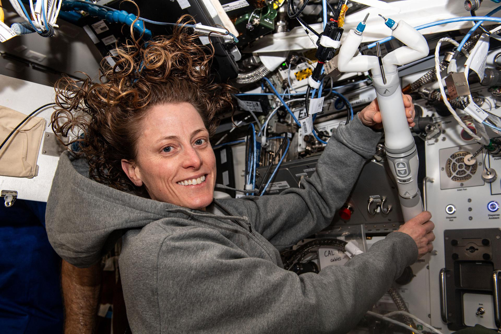 NASA astronaut and Expedition 70 Flight Engineer Loral O’Hara shows off the miniaturized in vivo robotic assistant (MIRA)