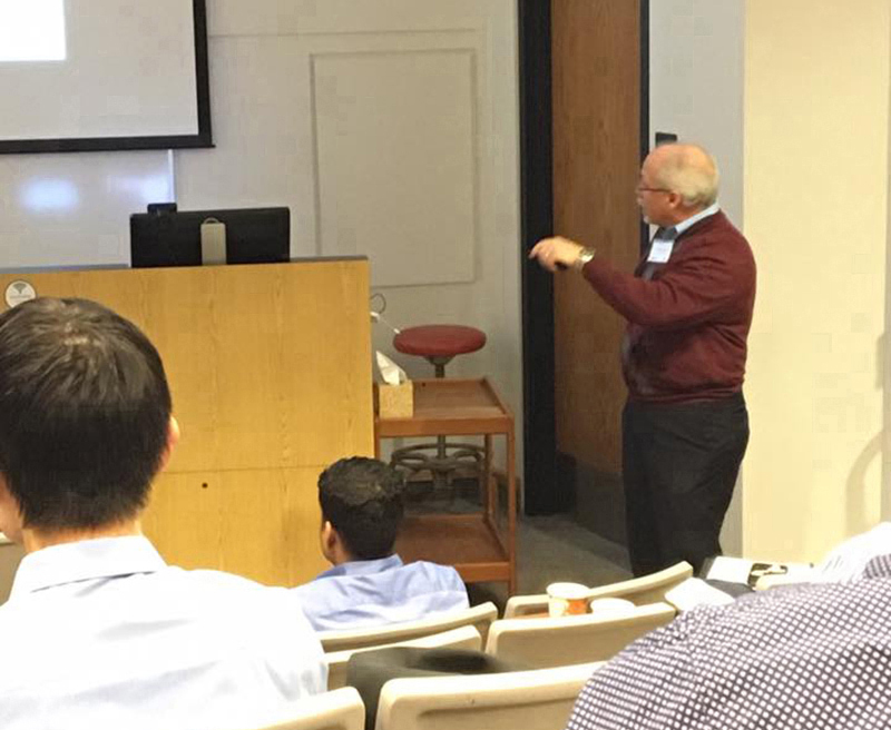 Dr. Soper giving a speech to a crowd in an auditorium.