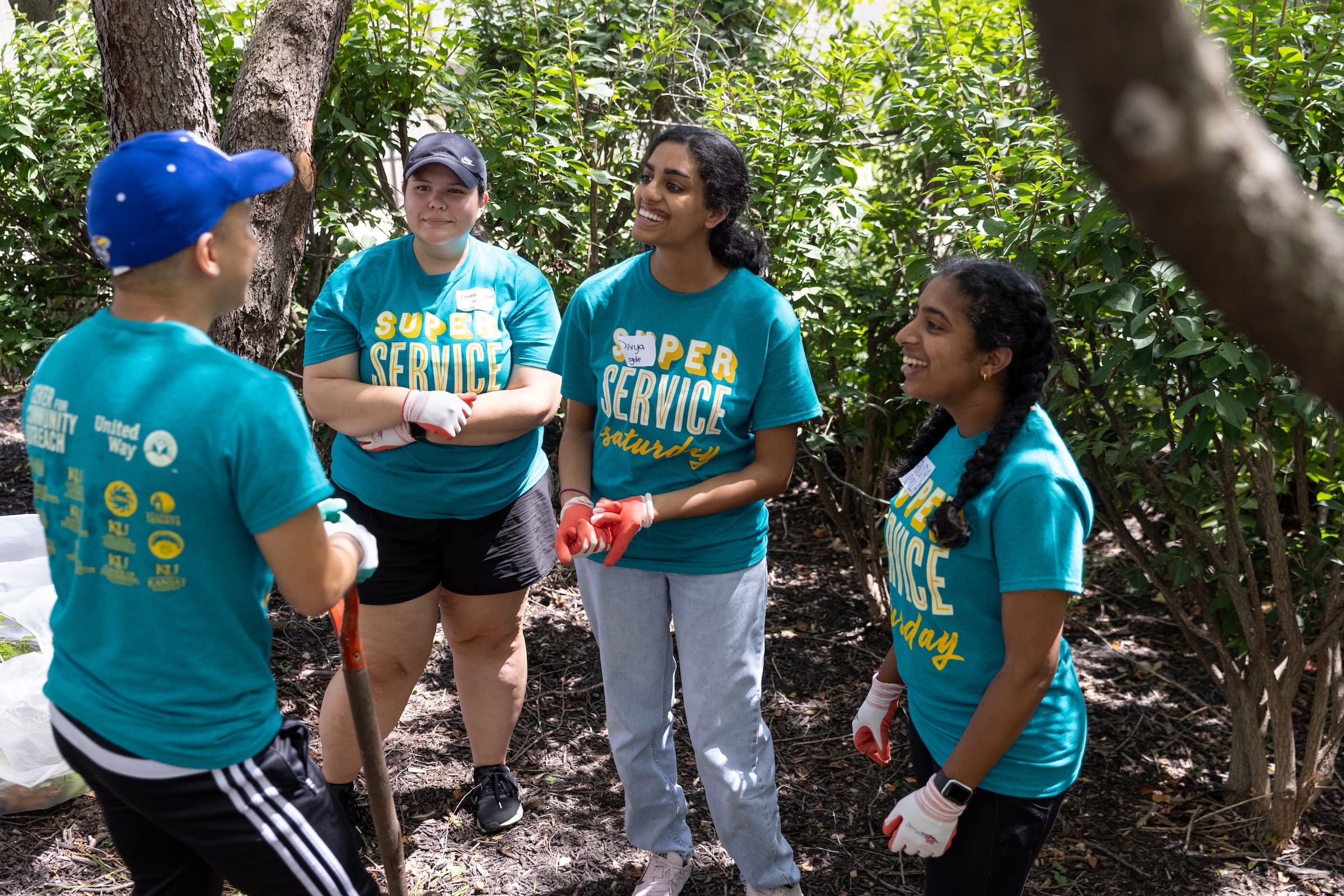 Super Service Saturday volunteers talking, smiling