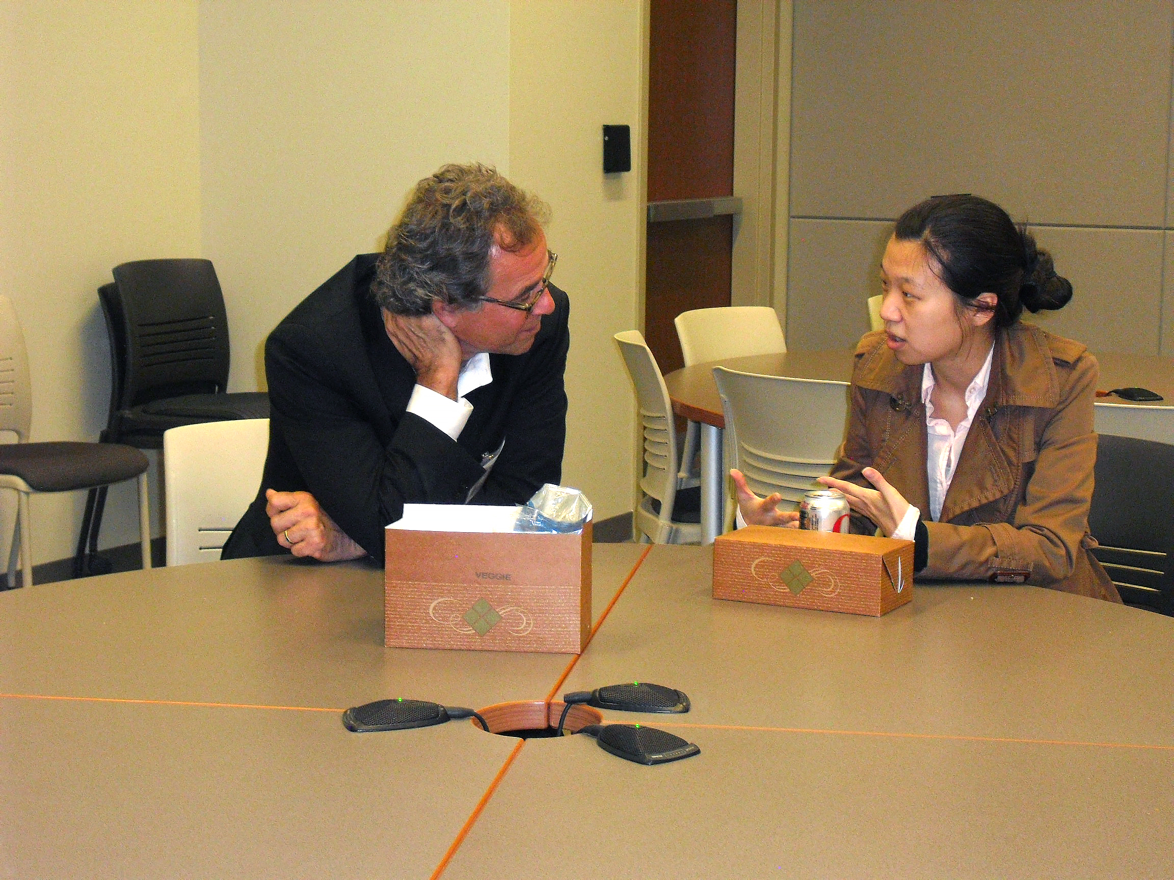 Two people sitting at a table, engrossed in conversation.