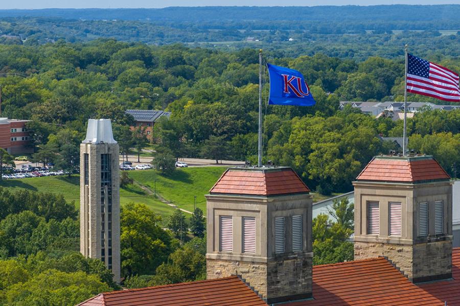 KU, Kansas flags atop Fraser Hall