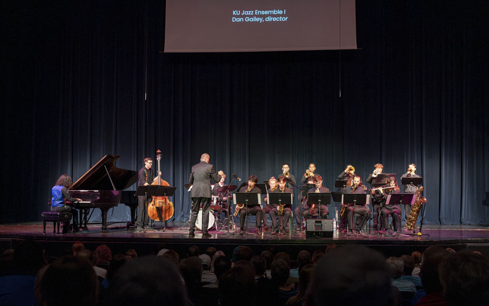 A group of musicians playing jazz instruments on a stage.