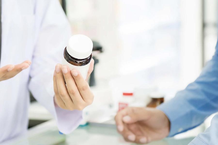 Stock photo of hands of pharmacist and customer during consultation