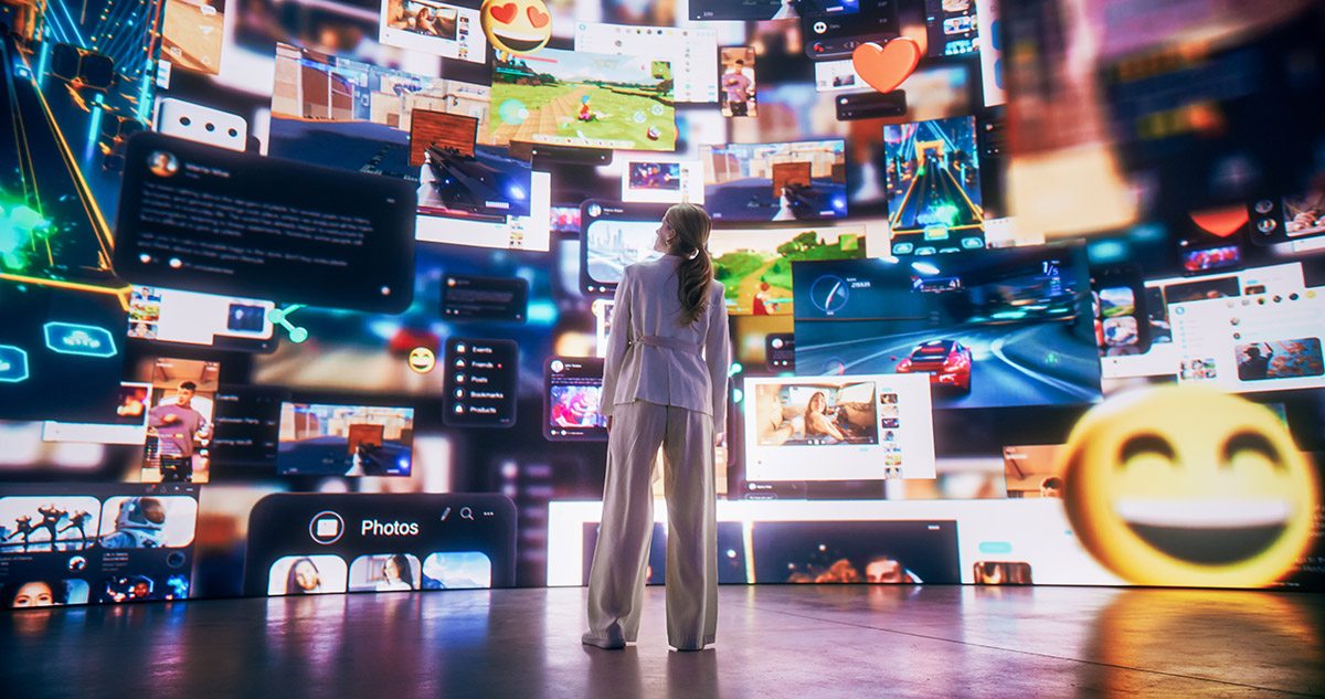 A photo of a woman from behind standing before a massive wall representing various websites, online and entertainment options including emojis and numerous online options.