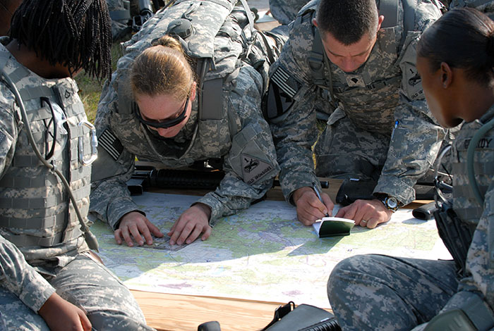 Members of the Special Troops Battalion, 1st Armored Division plot their positions on a map. Credit: Wikimedia Commons.